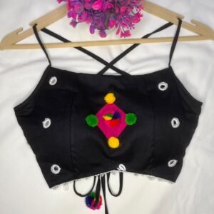 This black cotton crop top blouse, decorated with multicolor pompoms and mirror work, will add a fun, vibrant touch to your festive outfits.